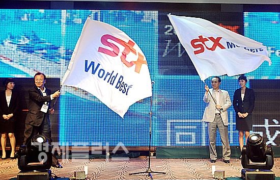 행사에 참석한 강덕수 STX그룹 회장(오른쪽)과 협력사인 한조 김승재 회장(왼쪽)이 각각 깃발을 흔들고 있다.
